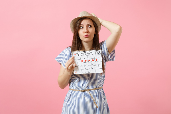 How can you delay your period for a vacation?