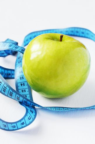 A healthy apple and measuring tape