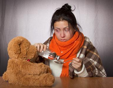 A woman administering a cold remedy