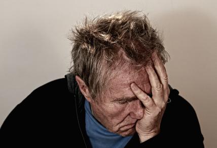 man waking up with a headache