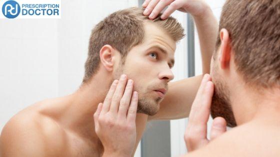 Man examining his hair line