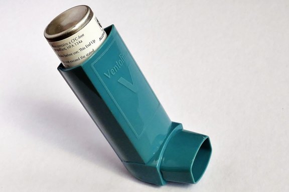 A blue ventolin reliever inhaler used to alleviate asthma symptoms
