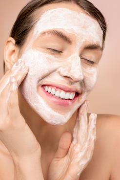 Woman washing her face with soap